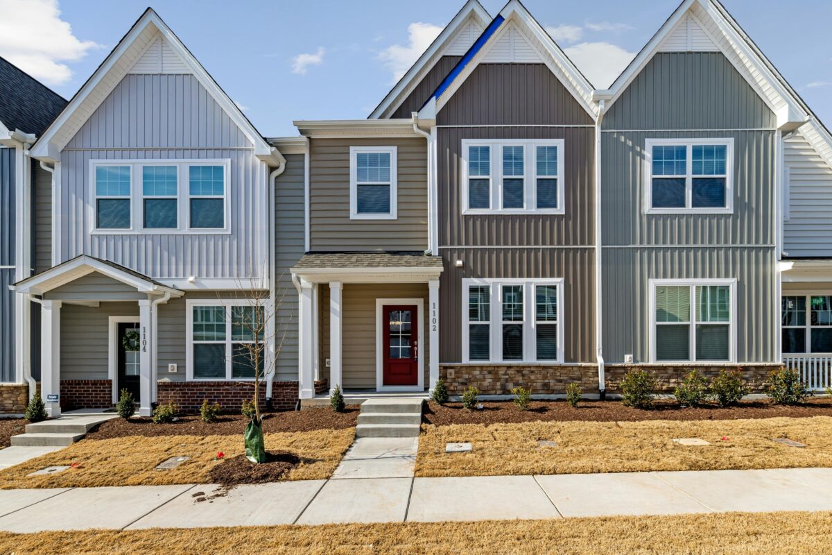 Charming modern townhouses in a suburban residential area with neat landscaping.